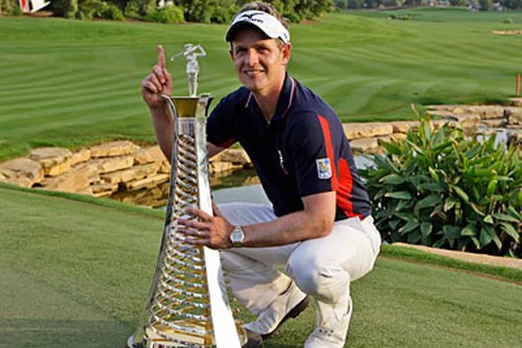 Luke Donald holds the Race To Dubai trophy after he won the European Championship tour. (Kamran Jebreili/AP)