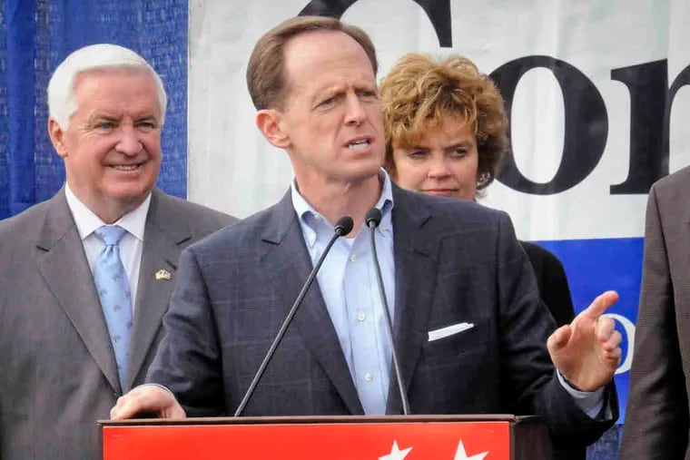 Pat Toomey, the GOP candidate for senator, makes a pitch for Tom Corbett, at the Lancaster rally with his wife, Susan.