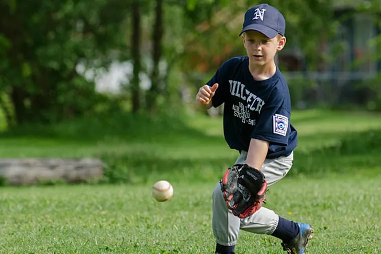 Owen Newcomer warms up before a Little League game in Williamsport, Pa. , May 28, 2014. Newcomer is the great grandson of Dick Hauser who played on one of the original Little League teams in 1939, making him a fourth generation Little Leaguer. (Ralph Wilson/AP)