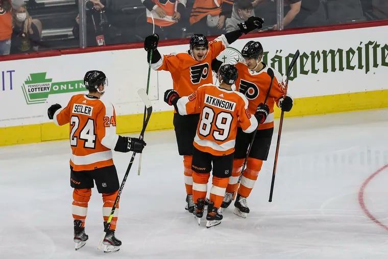 Flyers Egor Zamula, center celebrates with teammates after his goal against the Islanders during the second period at the Wells Fargo Center in Philadelphia, Tuesday,  September 28, 2021.