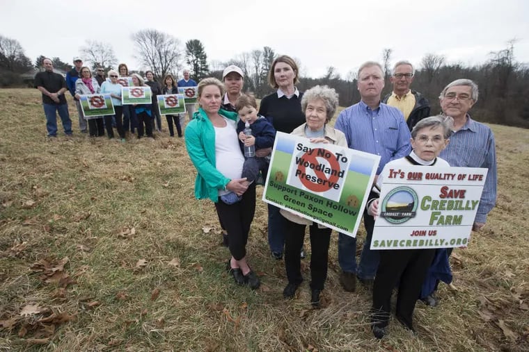 Members of an anti-development group pose on township owned land on March 1, 2017. One developer had proposed building a huge, 559-unit retirement community on the land where the tree line is in the background.  As open space dwindles in Delaware County, township officials have started pushing back on developer requests for huge projects. As a result, two big lawsuits against Marple Township. Part of the reason officials have been rejecting plans has been because of pushback from a highly-organized resident group, which mounted a tremendous anti-development campaign.