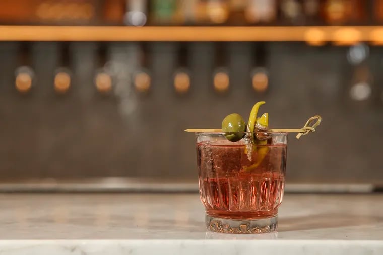 Fell to Earth, Pennsylvania's first vermoutherie, is holding a popup bar in Headhouse Square's Bodhi Coffee on Tuesdays and Wednesdays in March 2024. It's also moving into a production space in East Falls. Here, Batch #5 of Dumpster Juice Vermouth on the rocks.