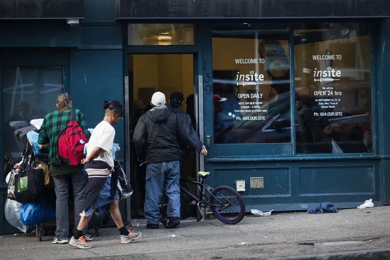 People enter Insite, the first supervised safe injection site in North America, in Vancouver in October 2016.