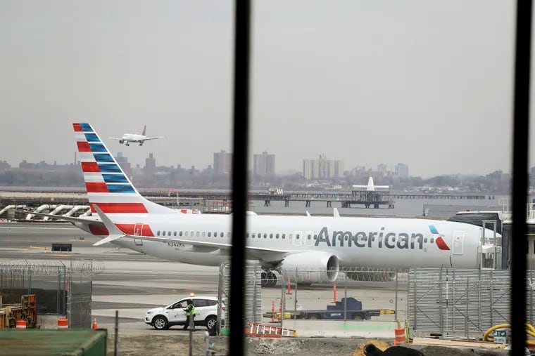 FILE - In a March 13, 2019 file photo, an American Airlines Boeing 737 MAX 8 sits at a boarding gate at LaGuardia Airport in New York. American Airlines expects to take a $1 billion hit from two things it didn't expect when 2019 started: That its newest Boeing jet would be grounded for months after two deadly crashes, and that oil prices would rise. (AP Photo/Frank Franklin II, File)