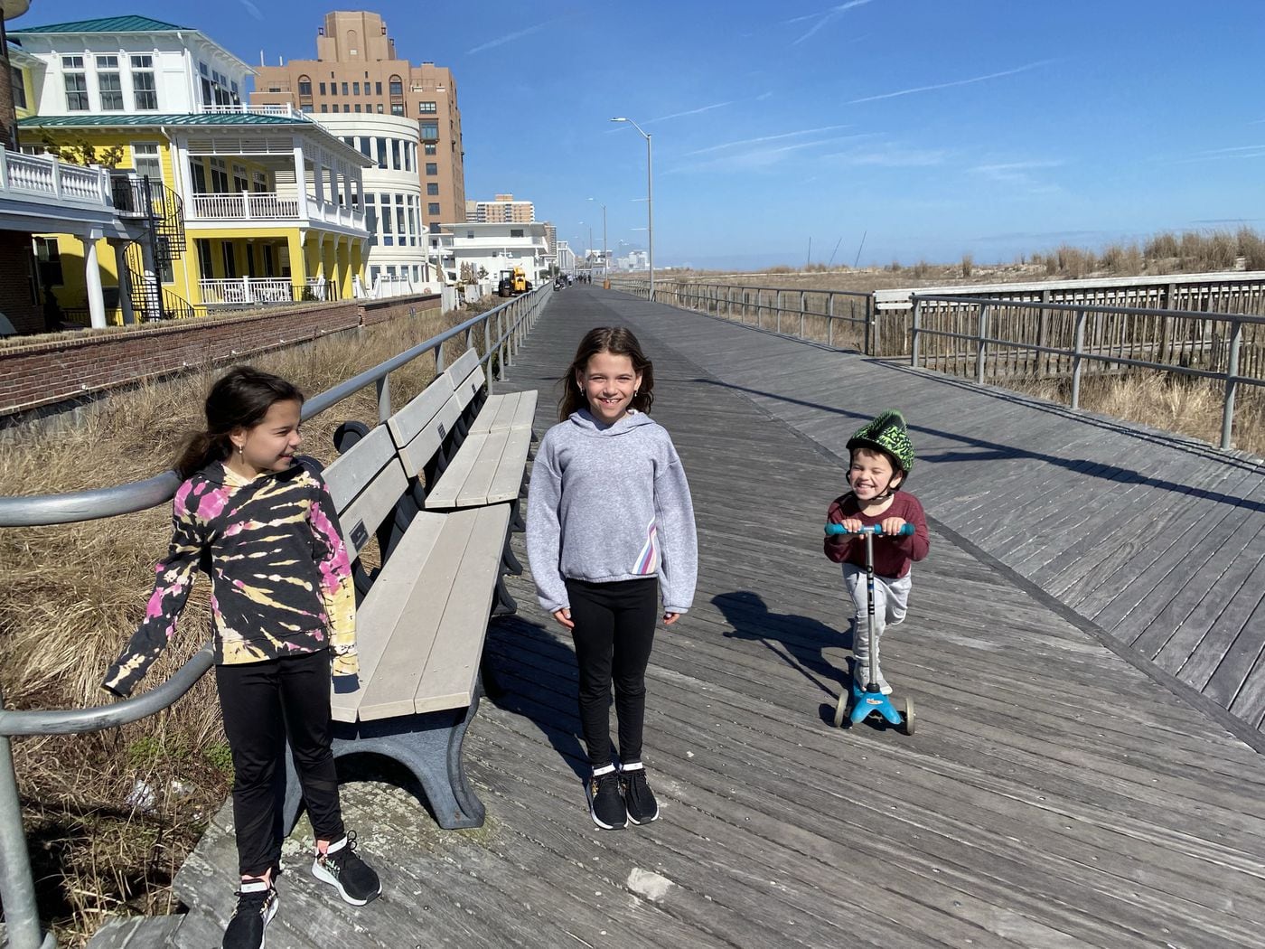The Fishman twins, second-graders from Philadelphia, and their cousin, on the Ventnor Boardwalk. Their mom, Rachel, says she came to their shore home "so my kids could have fresh air, more space."