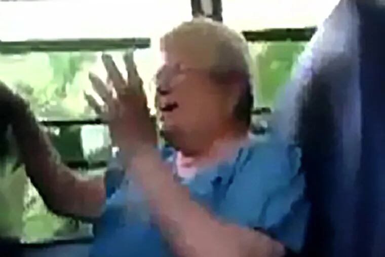 Karen Klein , 68,a bus monitor, reacts to the taunts from a small group of middle-school students on the ride home in Greece, N.Y. YouTube, AP