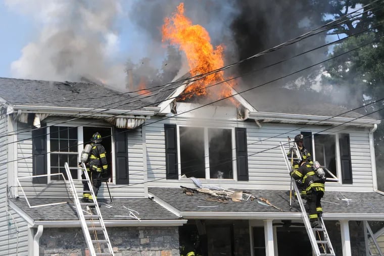 Firefighters go to work at a house fire in Bellmawr early Wednesday afternoon.
