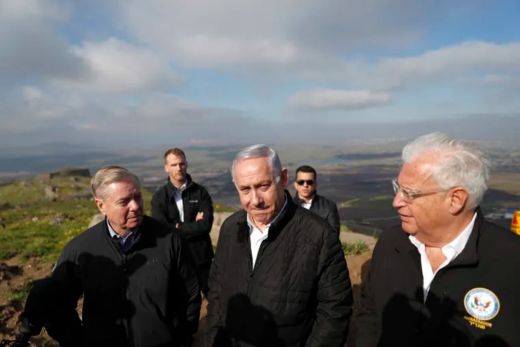 Israeli Prime Minister Benjamin Netanyahu, center, Republican U.S. Senator Lindsey Graham, left, and U.S. Ambassador to Israel David Friedman, right, visit the border between Israel and Syria at the Israeli-held Golan Heights, Monday, March 11, 2019. Graham says he will push for American recognition of Israeli sovereignty over the Golan Heights, a territory it captured from Syria in the 1967 Mideast war. (Ronen Zvulun/Pool via AP)