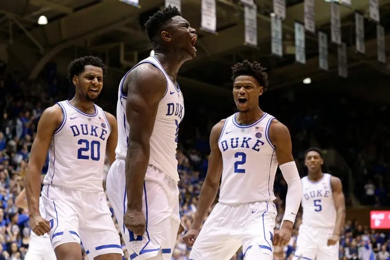 Duke's Zion Williamson, center, reacts with Marques Bolden (20), Cam Reddish (2) and RJ Barrett (5) following a play against St. John's during the second half of an NCAA college basketball game in Durham, N.C., Saturday, Feb. 2, 2019. Duke won 91-61. (AP Photo/Gerry Broome)