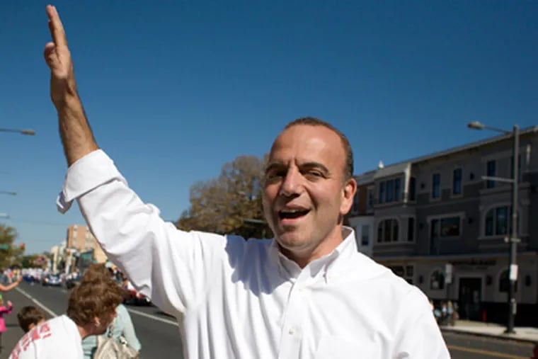 Dan Onorato, Democratic nominee for governor, waving to potential voters on Broad Street for the Columbus Day Parade. (Ed Hille / Staff Photographer)