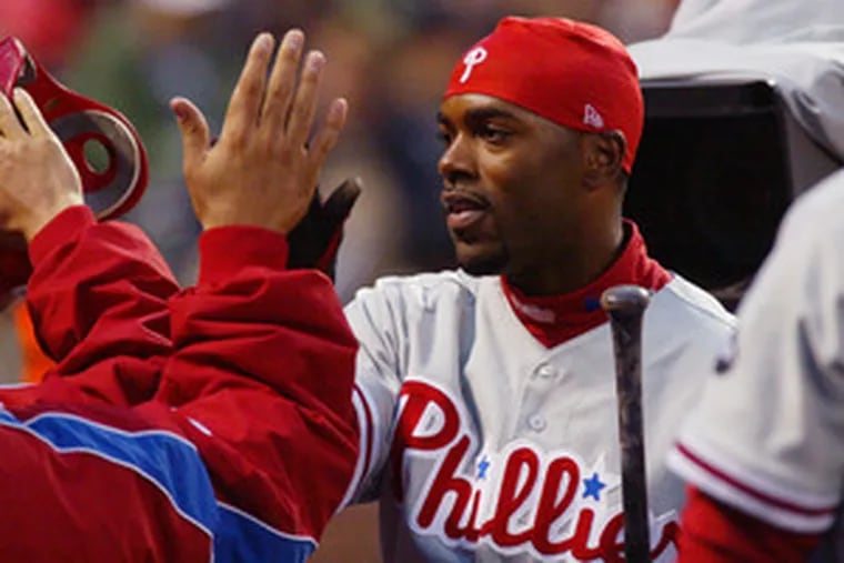 Jimmy Rollins is greeted after scoring in the second inning of last night&#0039;s game against the Giants.