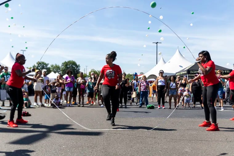 Vernell Prince, captain of the 40+ Double Dutch Club, performs with the group at Deptford Mall for the football fest benefiting Deptford Township L.E.A.D. program in Deptford, N.J.