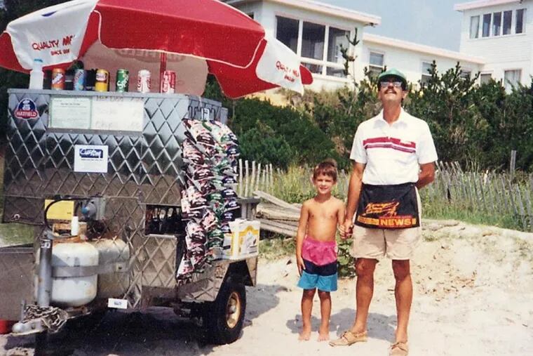 LouDogs founder Lou Subashi stands on the beach at Sea Isle City with his hot dog cart and his son, Christian, then 5.