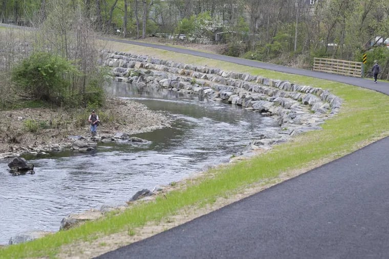 Bob Wargo spin casts for trout beside Delaware County's $6.5M, 2.8-mile Chester Creek Trail, the 20-year dream of the late Mark Fusco from Aston, who wanted everyone to experience his profound love of nature.
