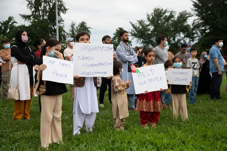 Children hold signs up during a rally in solidarity with the people of Afghanistan and the Afghan community in Philly at Tarken Recreation Center in Northeast Philadelphia, Pa. on Sunday, August 22, 2021. Speakers called for safe travel and expedited processing for those fleeing persecution in Afghanistan.