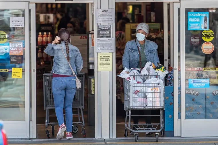 Both customers entering and exiting the Acme grocery store on Ridge Avenue in Roxborough were wearing masks as a personal protection against the spread of the coronavirus.