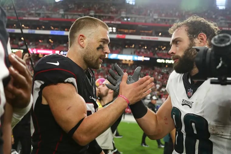 Arizona Cardinals tight end Zach Ertz (left) with former teammate Dallas Goedert of the Eagles after a game on Oct. 9, 2022.