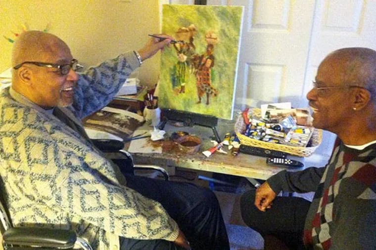 Artist Horace Broughton (left) at work in his Deptford, NJ home with his younger brother, Robert Broughton, of Glassboro, NJ. (Kevin Riordan / Staff)