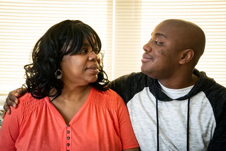 Cecelia Thompson (left) and her son Trevor Thompson, 22, in Trevor's room in their Philadelphia home. Cecelia is the primary caregiver for her son, who lives with severe autism and an intellectual disability.