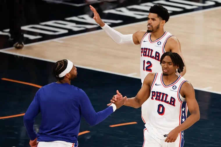Sixers guard Tyrese Maxey with teammates guard Buddy Hield (left) and forward Tobias Harris after the Sixers beat the New York Knicks in Game 5.