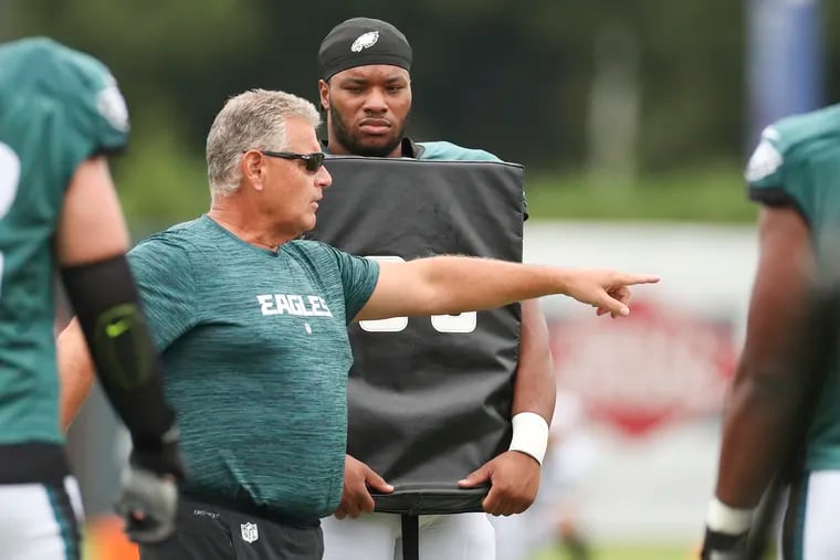 Eagles rookie Tyler Steen listens to offensive line coach Jeff Stoutland during training camp practice at the NovaCare Complex on Friday.