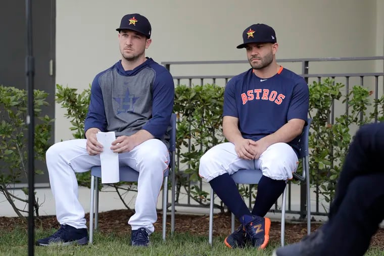 Houston Astros infielder Alex Bregman, left, and teammate Jose Altuve sit in chairs as the wait to deliver statements during a news conference before the start of the first official spring training baseball practice for the team Thursday, Feb. 13, 2020, in West Palm Beach, Fla. (AP Photo/Jeff Roberson)