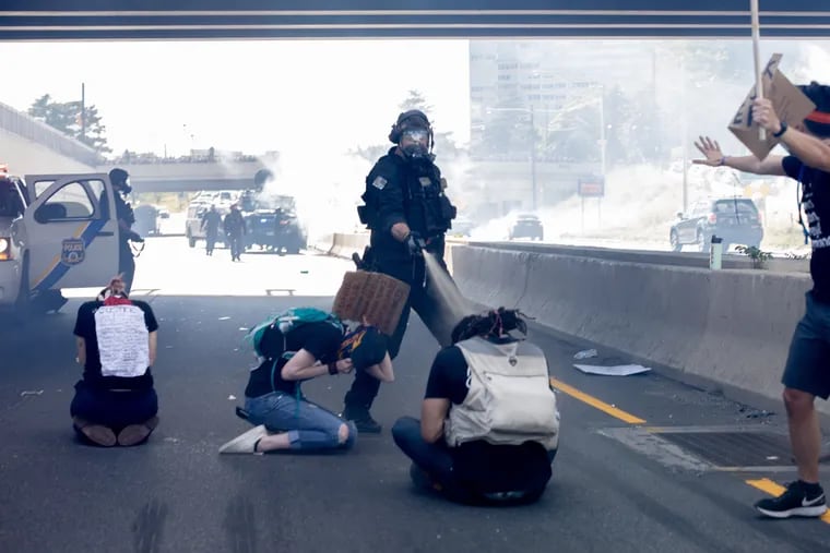 Philadelphia SWAT Officer Richard P. Nicoletti pepper spraying three kneeling protesters on I-676 on June 1, 2020.