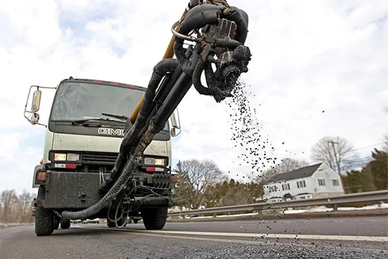 A Pothole Killer truck, brainchild of a Harleysville entrepreneur, spews a mix of asphalt and cement on U.S. 1 in Neshaminy, cleaning, filling, and obliterating a pothole in about 90 seconds.