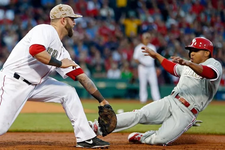 Boston's Mike Napoli puts the tag on  Ben Revere as he is doubled off first base in the third inning. (Michael Dwyer/AP)