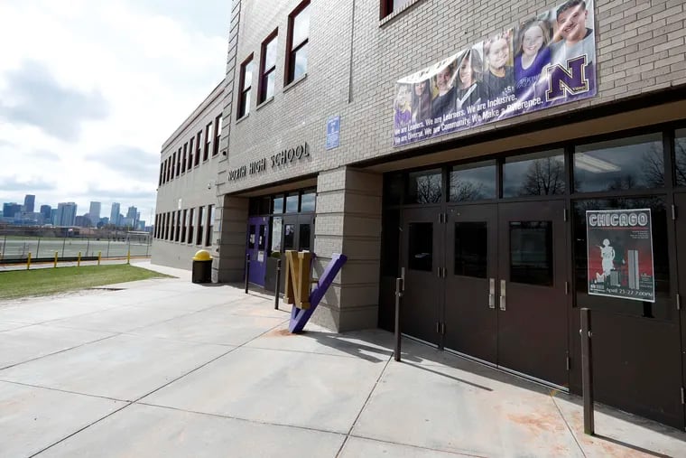 Doors are locked at North High School, Wednesday, April 17, 2019, in Denver. Denver-area public schools closed Wednesday as the FBI hunted for an armed young Florida woman who was allegedly "infatuated" with Columbine and threatened violence just days ahead of the 20th anniversary of the attack. (AP Photo/David Zalubowski)