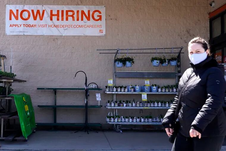 A hiring sign is seen outside a home-improvement store in Mount Prospect, Ill.