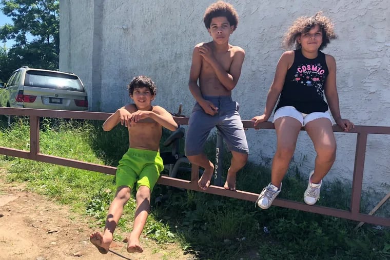 Siblings Paul Miller, 12, Ania Crawley, 9 and Jermiah Morales, 8, near 11th and Wyoming discuss their summer plans.