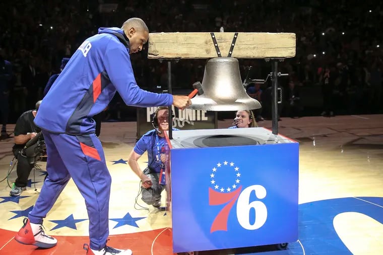 Sixers' Al Horford rings the bell before their game with the  Celtics at the season home opener at the Wells Fargo Center.