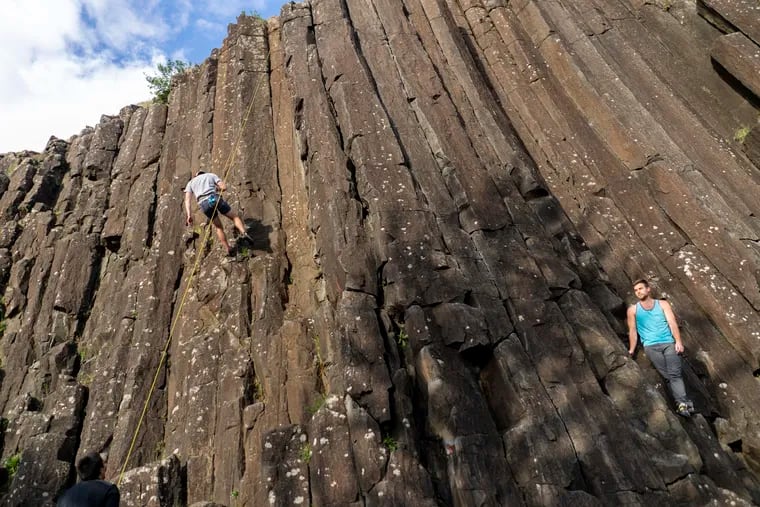 Climbers ascend and descend the Skinner Butte Columns in Eugene, Ore., earlier this month. The Pacific Northwest has become a coronavirus hot spot.