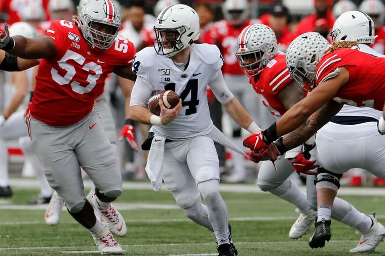 Ohio State defensive lineman Davon Hamilton, left, defensive lineman Taron Vincent, second from right, and defensive end Chase Young, right, put the pressure on Penn State quarterback Sean Clifford during the first half of an NCAA college football game Saturday, Nov. 23, 2019, in Columbus, Ohio.