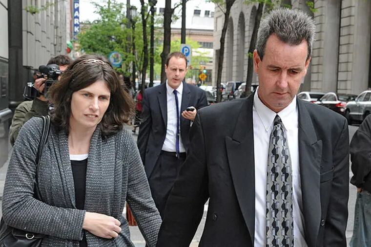 Holding hands, Catherine and Herbert Schaible leave the Criminal Justice Center after a probation hearing May 6, 2013.  The very religious couple, who were convicted of involuntary manslaughter in the 2009 death of a 2-year-old son because they denied him medical care, were in court because their 8-month-old son Brandon died recently under similar circumstances.  ( CLEM MURRAY / Staff Photographer )