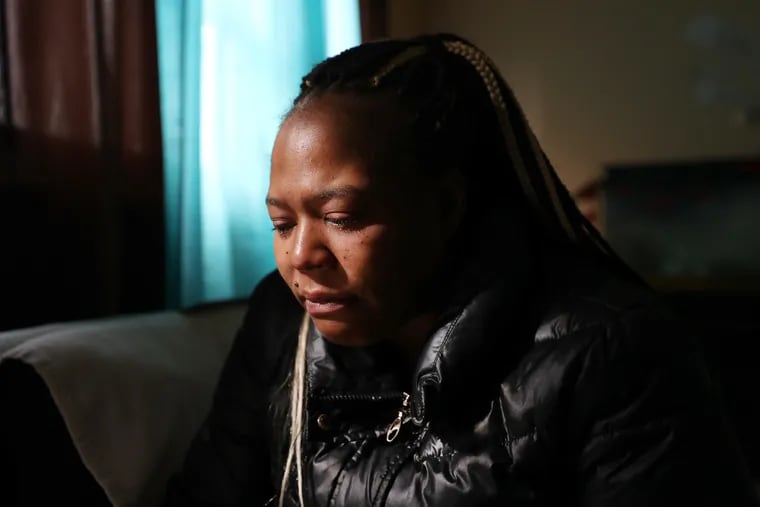 Ayanna Grabe, mother of Yaniyah Foster, cries as she talks about her daughter at her home in Philadelphia. Yaniyah was shot outside her home on Wednesday and died at the hospital.