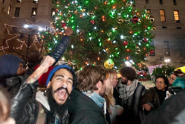 People protesting the death of Michael Brown surround the 21st annual Christmas Tree Lighting ceremony at City Hall on Dec. 3, 2014.