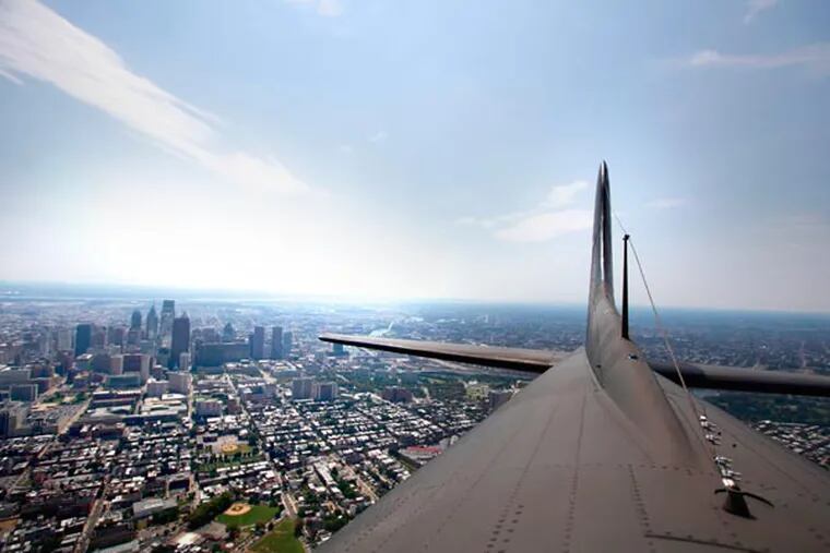 Philadelphia can be seen over the tail section of the Memphis Belle that flew over Philadelphia, Monday 27, 2013. ( DAVID SWANSON / Staff Photographer )