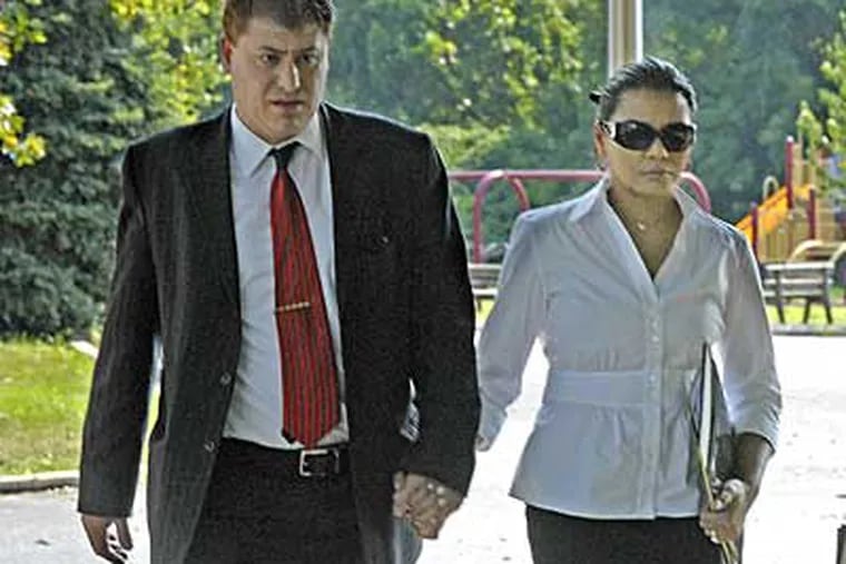 File photo of Angela Honeycutt, accused of engaging in sex acts with two teenage boys, arriving at a preliminary hearing in July with an unidentified man. (April Saul / Staff Photographer)