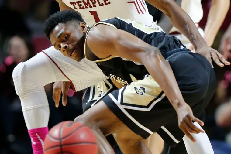 Temple's Josh Brown watches as Central Florida's Chance McSpadden loses control of the dribble during the Owls' American Athletic Conference win.