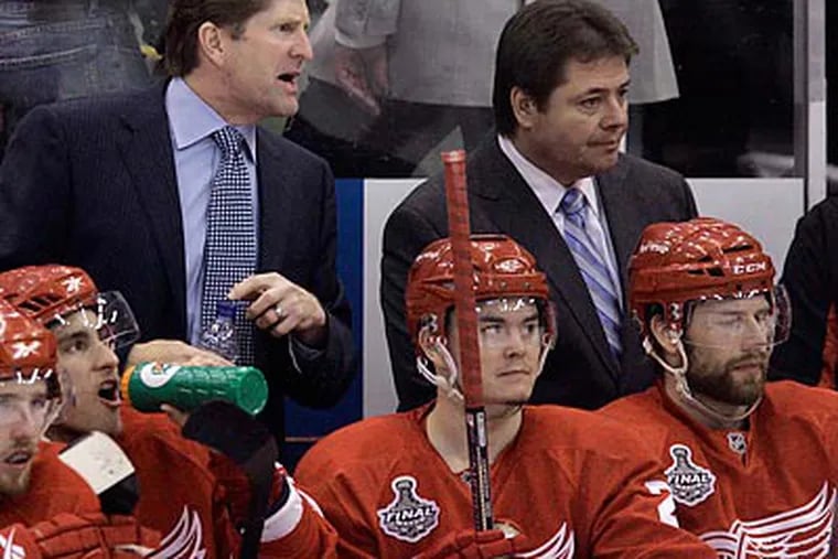 Brad McCrimmon (right) left the Detroit Red Wings in May to pursue a head coaching opportunity in Russia. (Carlos Osorio/AP file photo)