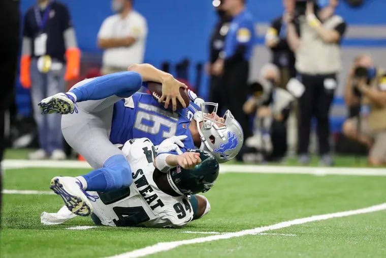 Detroit Lions quarterback Jared Goff (16) is taken down for the second time in the first quarter by Philadelphia Eagles defensive end Josh Sweat (94) Sunday, October 31, 2021 at Ford Field in Detroit, Michigan.