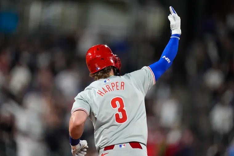 Bryce Harper gestures following his three-run home run off Colorado relief pitcher John Curtiss during the ninth inning of the Phillies eventual 8-4 win over the Rockies on Saturday.