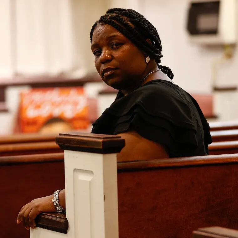 Andrea Robinson sits inside the United Church of the First Born in North Philadelphia before the start of an anti-violence event on May 27.