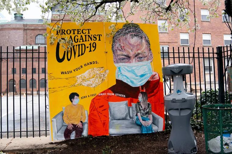 A new mural painted by Nilé Livingston promotes hand washing and good health practices during the coronavirus at a hand-washing station on the 1700 Block of  Vine Street., March 25, 2020. To encourage hand washing and protect the vulnerable, Broad Street Ministry partnered with Mural Arts Philadelphia, StreetsDept.com, and HAHA MAG to install portable hand-washing stations and informational murals  across the city.