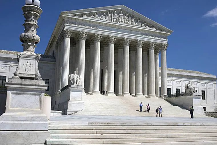 FILE - In this April 26, 2014 file photo, people walk on the steps of the U.S. Supreme Court in Washington. The Supreme Court said Monday that a Lansdale poison case was not about terrorism but was instead just a love triangle.  (AP Photo/Jacquelyn Martin/File)