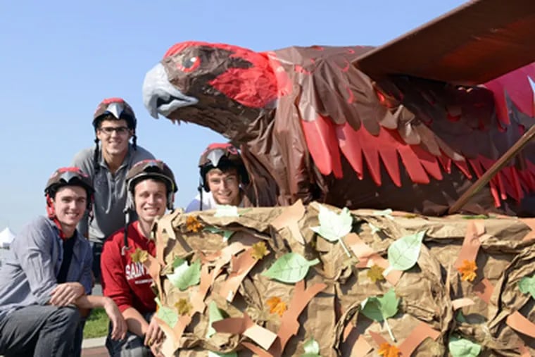 With their St. Joe's hawk are (from left) Mark McShane, Daniel Ezzo, Nicholas Shafer, and Kyle Smith. (TOM GRALISH / Staff Photographer)