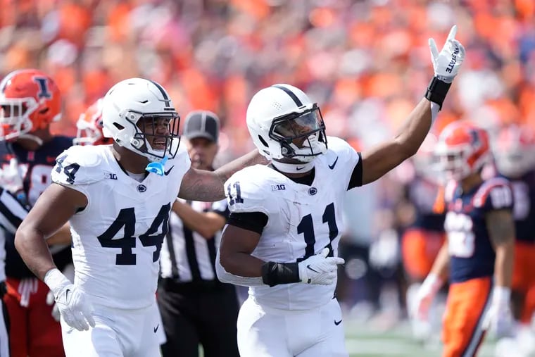 Penn State linebacker Abdul Carter (11) celebrates his interception with Chop Robinson during the first half of Saturday's game against Illinois.