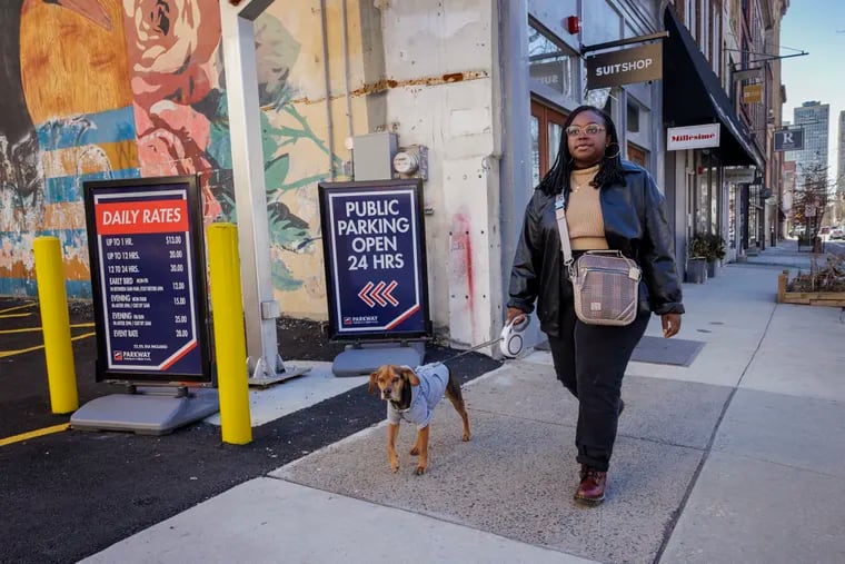 Dajè Walker and her dog, Moose, enjoy walking around Old City. They are blissfully carless because of the high cost of ownership.